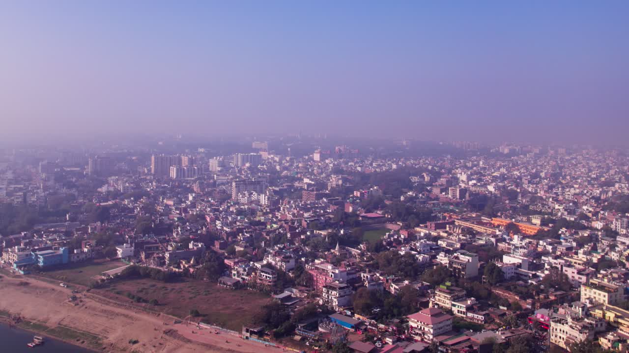 banaras city with haze and water at varanasi, kashi, uttar pradesh, india. day time, pan shot, raising up shot, drone shot, 4k.