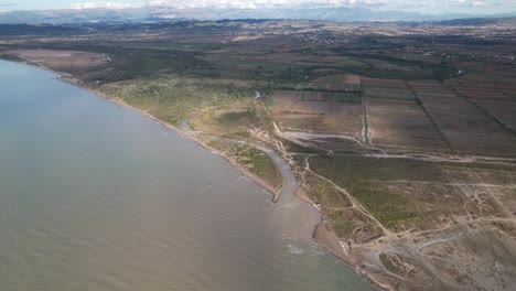 Muddy-water-of-river-mixing-with-blue-seawater-on-cost-of-Adriatic-sea-in-Albania