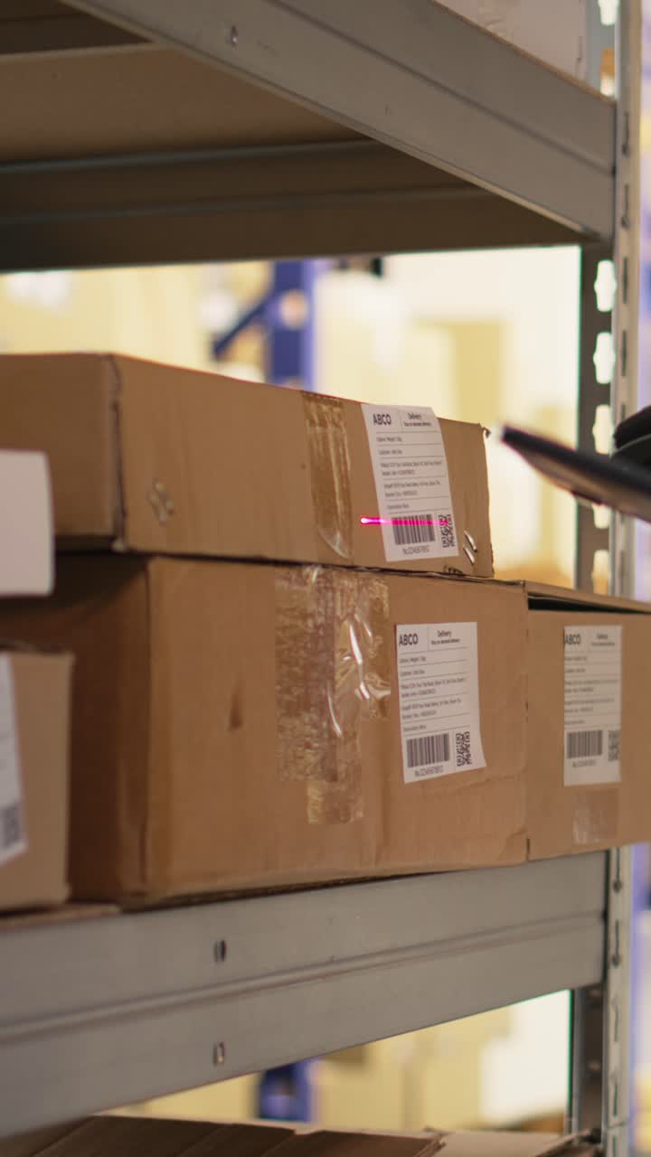 Vertical Video Close up of black worker using a barcode scanner to process shipping labels