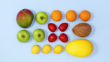 fresh ripe fruits making  vibrant and creative layout on bright blue background. stop motion flat lay