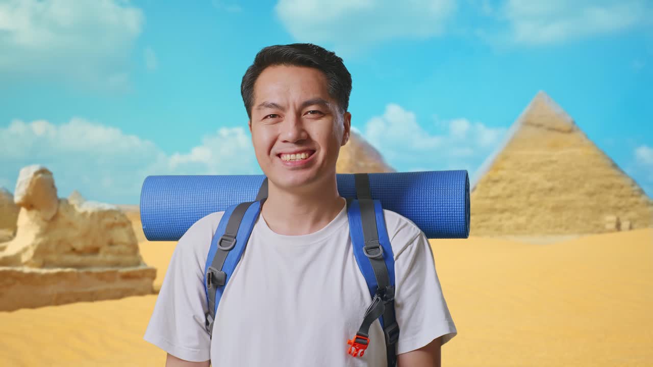 Close Up Of Asian Male Hiker With Mountaineering Backpack Smiling To Camera While Traveling In Pyramid Of Giza