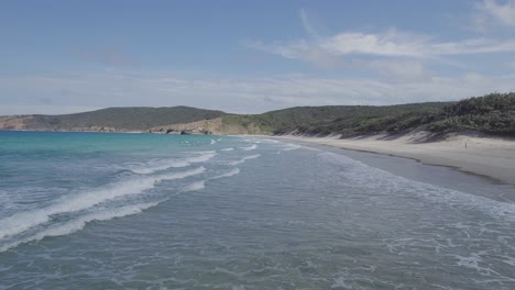 Waves-Rolling-To-The-Shoreline-Of-Wreck-Beach-In-Summer---Great-Keppel-Island,-QLD,-Australia