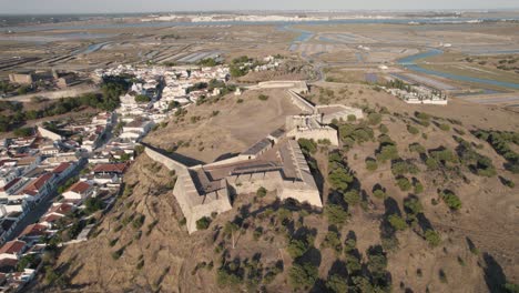 Aerial-circular-pan-shot,-Forte-de-Sao-Sebastiao-in-old-town-of-Castro-Marim,-Algarve,-Portugal