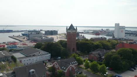 Birds-eye-around-the-Water-Tower-of-Esbjerg,-Denmark.-Esbjerg-Water-Tower-is-an-danish-landmark-at-the-top-of-a-cliff-overlooking-the-harbor.-Slow-camera-rotation