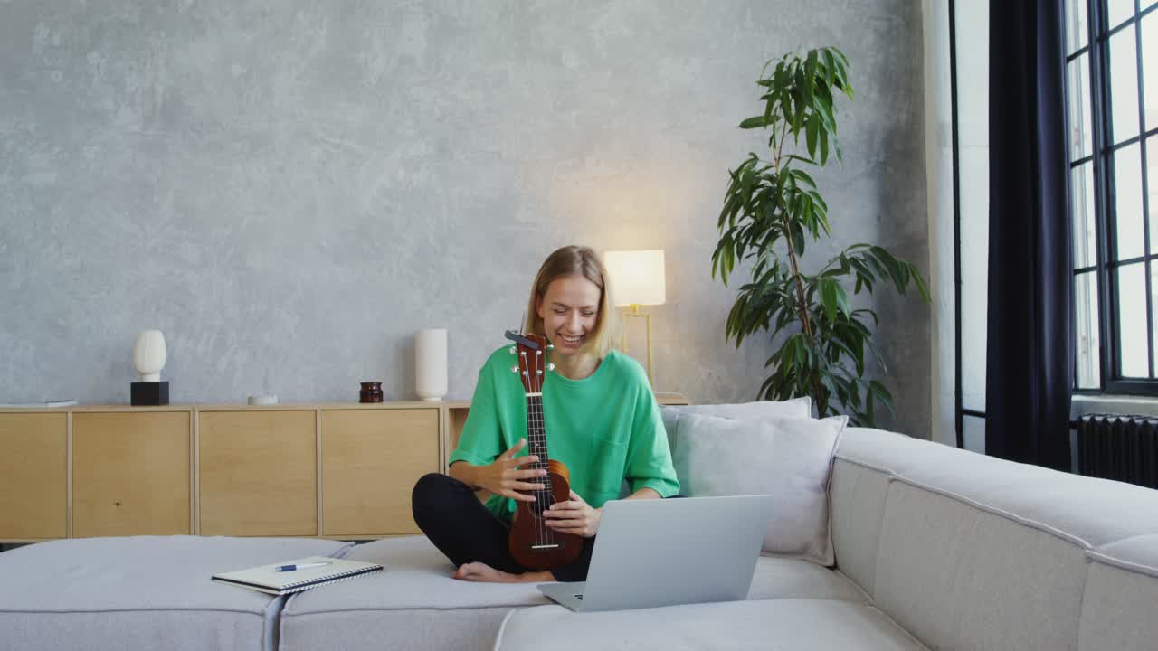 Woman learning ukulele online