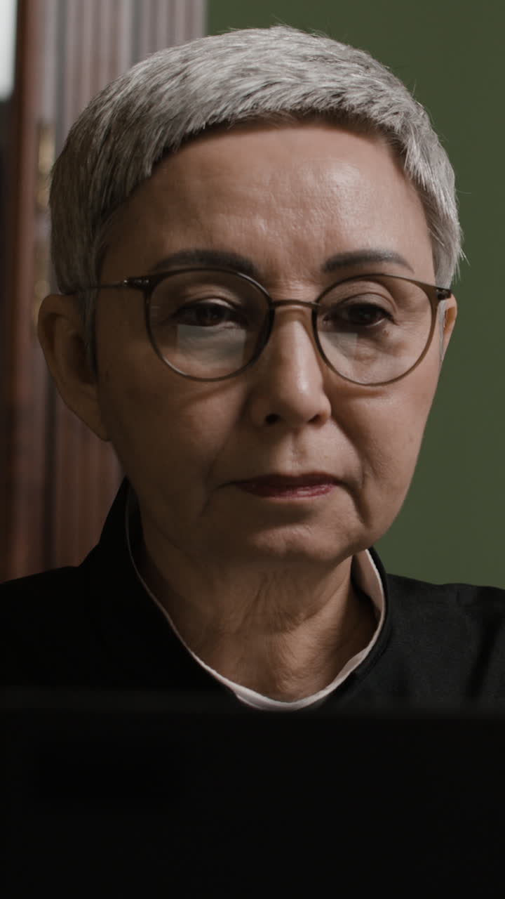 Older Asian Woman Working on Laptop