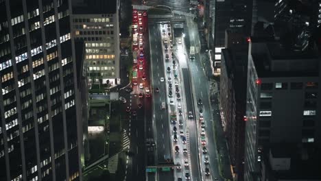 Bustling-Road-In-Shibuya-Cityscape-In-Tokyo,-Japan-At-Night---high-angle,-hyper-lapse