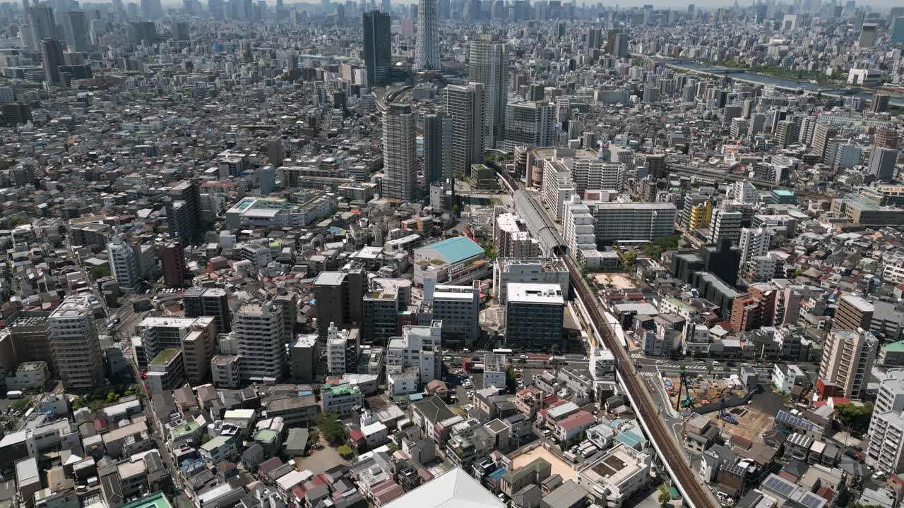 Aerial Scenic Urban Drone Footage of a neighborhood, streets and buildings in the Capital City of Tokyo, Japan on a Sunny Day