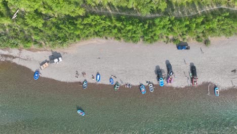 Top-View-Of-Rafters-Docked-On-Flathead-Rivershore-During-Summer-In-North-Fork,-Montana,-USA