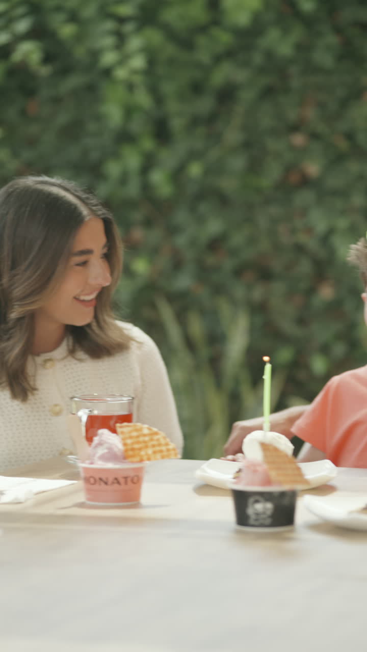 Wide shot of a boy celebrating his birthday in a family setting, surrounded by joy and confetti. A vibrant and colorful scene that conveys happiness, fun, and childlike excitement.