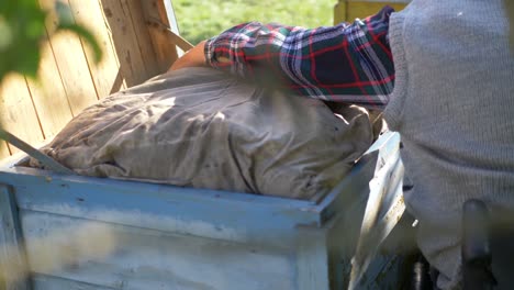 the beekeeper inserts a warm bedding inside a bee beehive