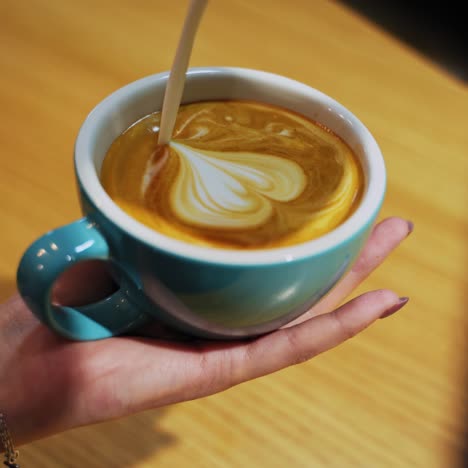 female hands pouring milk