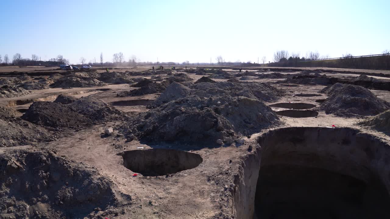 Large opening to pit at archaeology site; pan down left to right