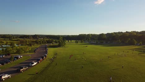 Children-training-soccer-for-Sunday-match-at-Liberty-Park,-Clarksville,-Tennessee,-USA---aerial-over-grassy-area