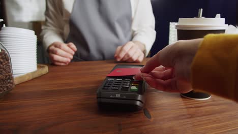 paying with credit bank card in cafe. touch-free and contactless food shopping in restaurant. nfc technology concept.