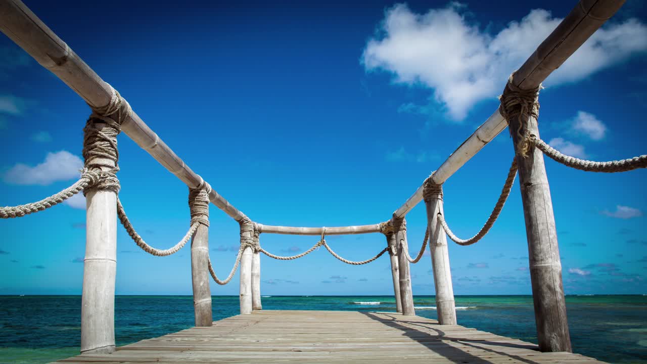 Wood bridge on the beach near the ocean timelapse