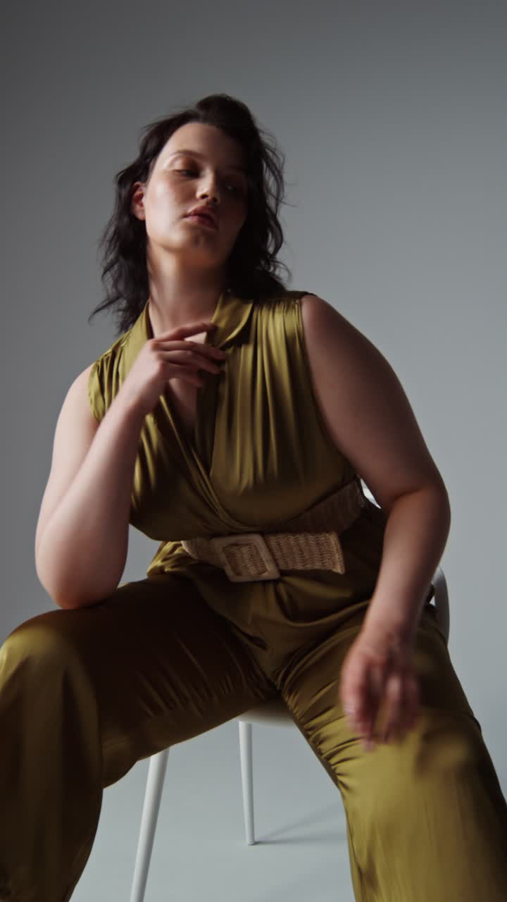 A woman in a stylish jumpsuit poses for a photoshoot