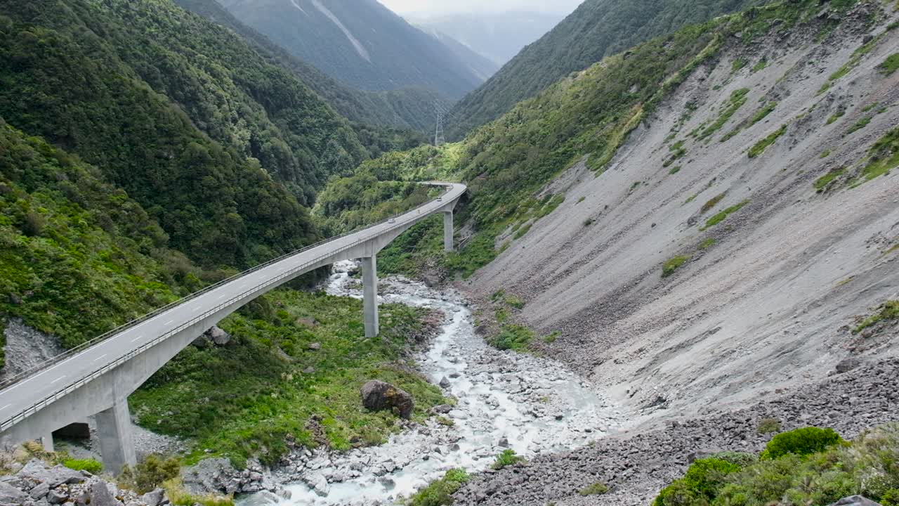 cars travelling across the Arthurs Pass viaduct in the Southern Alps of New Zealand