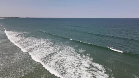 Static-aerial-shot-of-waves-crashing-onto-Nantasket-Beach,-Hull,-MA