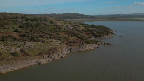 Wide-view-of-rugged-English-coastline-with-hills-revealed-in-distance-at-Silverdale-UK