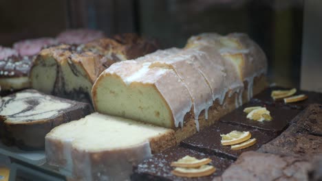 assorted cakes and brownies in a display case