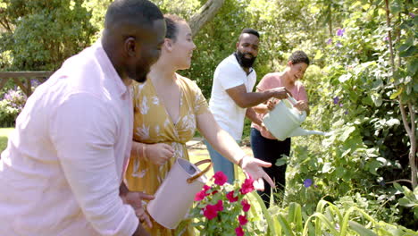 watering plants together, diverse friends enjoying gardening and outdoor activity