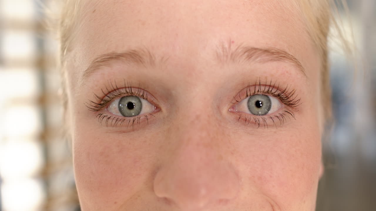 Close-up of woman with blue eyes focusing during disability rehabilitation session