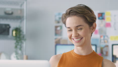 Female-Architect-In-Office-Making-Video-Call-At-Desk-On-Laptop