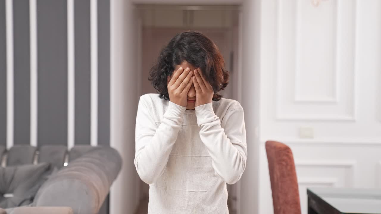 Small Indian kid boy having a headache