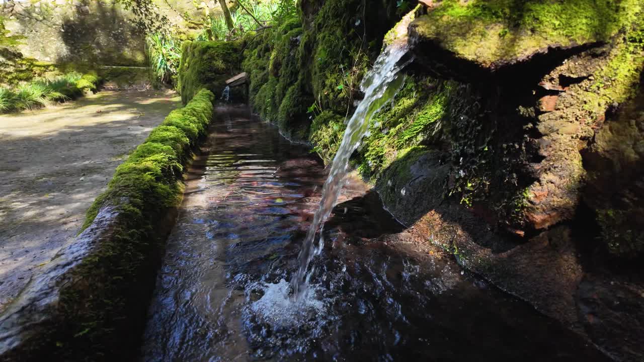 Slowmotion cinematic view of manmade waterfall near Pena Palace