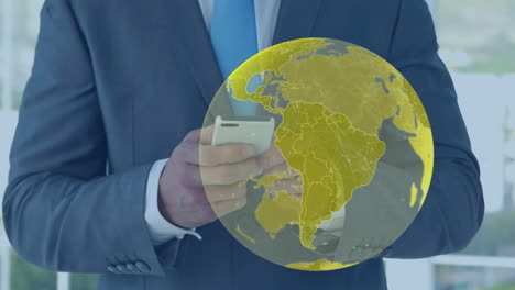 animation of yellow global network over businessman using smartphone