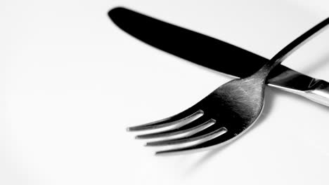 knife and fork on white surface close up video