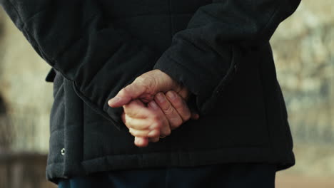 hand of an elderly country gentleman moves in silhouette in the village