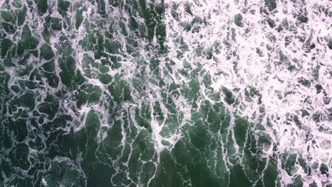 waves-crashing-by-the-seashore-on-stormy-day-aerial-drone-view-of-wild-beach-in-the-coastline-of-Spain