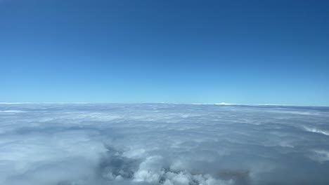 a pilot’s perspective: overflying a layer of stratus clouds during the descent for funchal airport in a stormy spring moorning