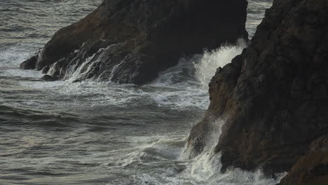 pacific ocean waves breaking under cliffs of american coastline, slow motion 120 fps