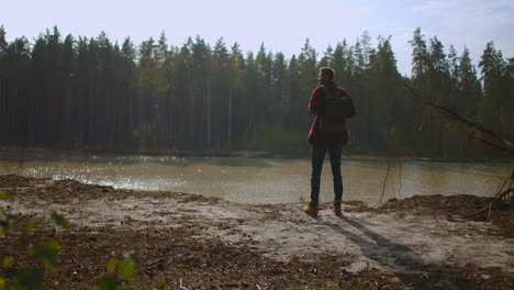 Man-traveling-relaxing-alone-with-river-canyon-view.-Man-survival-traveling-hiking-at-river-active-healthy-lifestyle.-High-quality-4k-footage