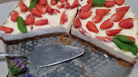 close-up of fresh homemade cheesecake new york with strawberries and mint on metal tray, 4k