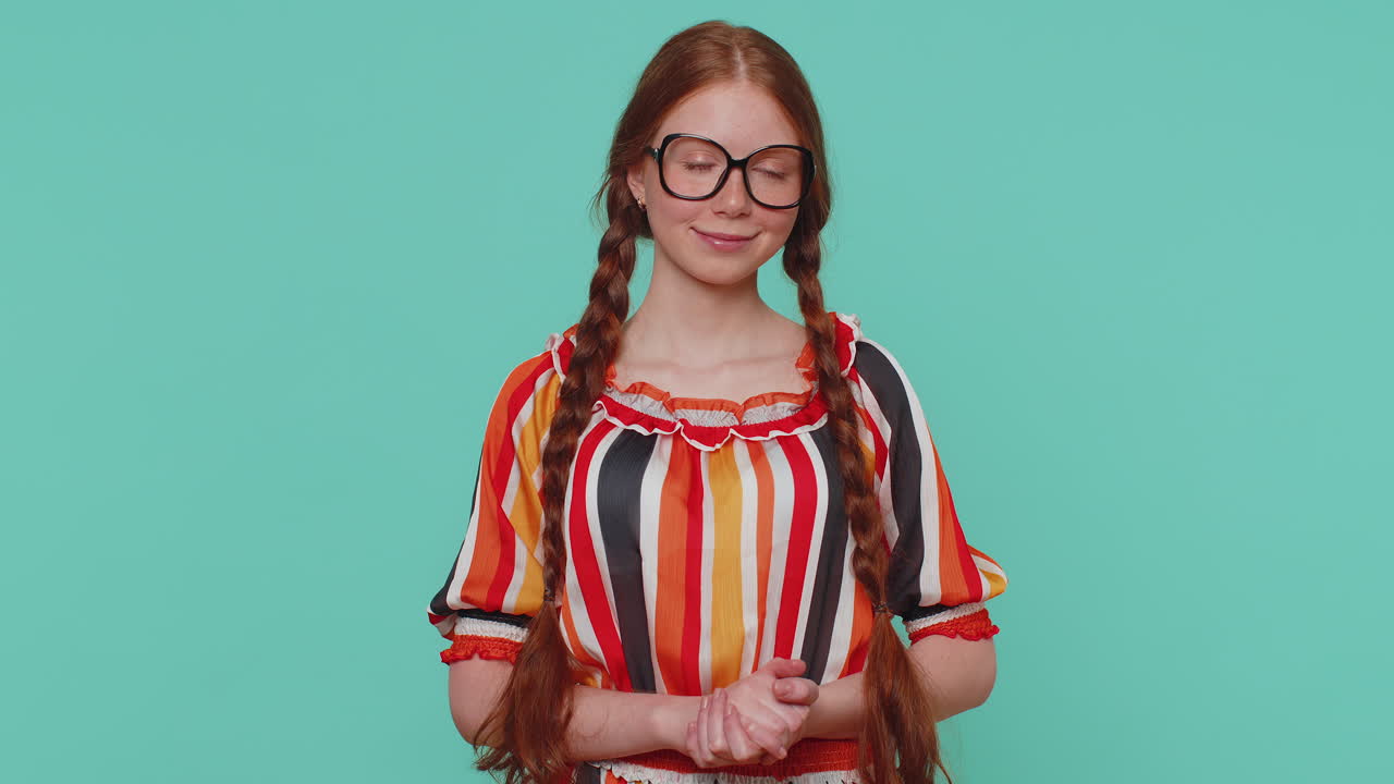 Lovely cheerful girl approves suggestion, shaking head approvely, satisfied with good work, like