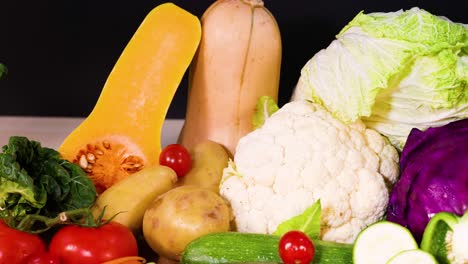 assorted vegetables arranged on a black background