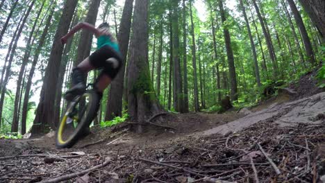 woman riding unicycle in the forest 4k