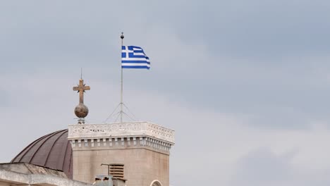 greek flag flying on church