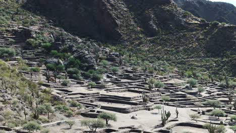 aerial: historical ruins in the desert mountain landscape of ciudad sagrada de quilmes, argentina