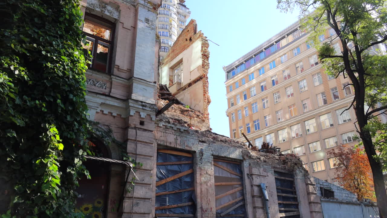 Destroyed and demolished civilian building by a big rocket in Kyiv Ukraine, critical war damage in the city capital, Russia attacks Ukraine, uninhabitable building, half of a house gone, 4K tilting up