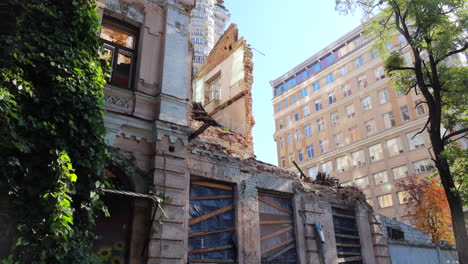 destroyed and demolished civilian building by a big rocket in kyiv ukraine, critical war damage in the city capital, russia attacks ukraine, uninhabitable building, half of a house gone, 4k tilting up