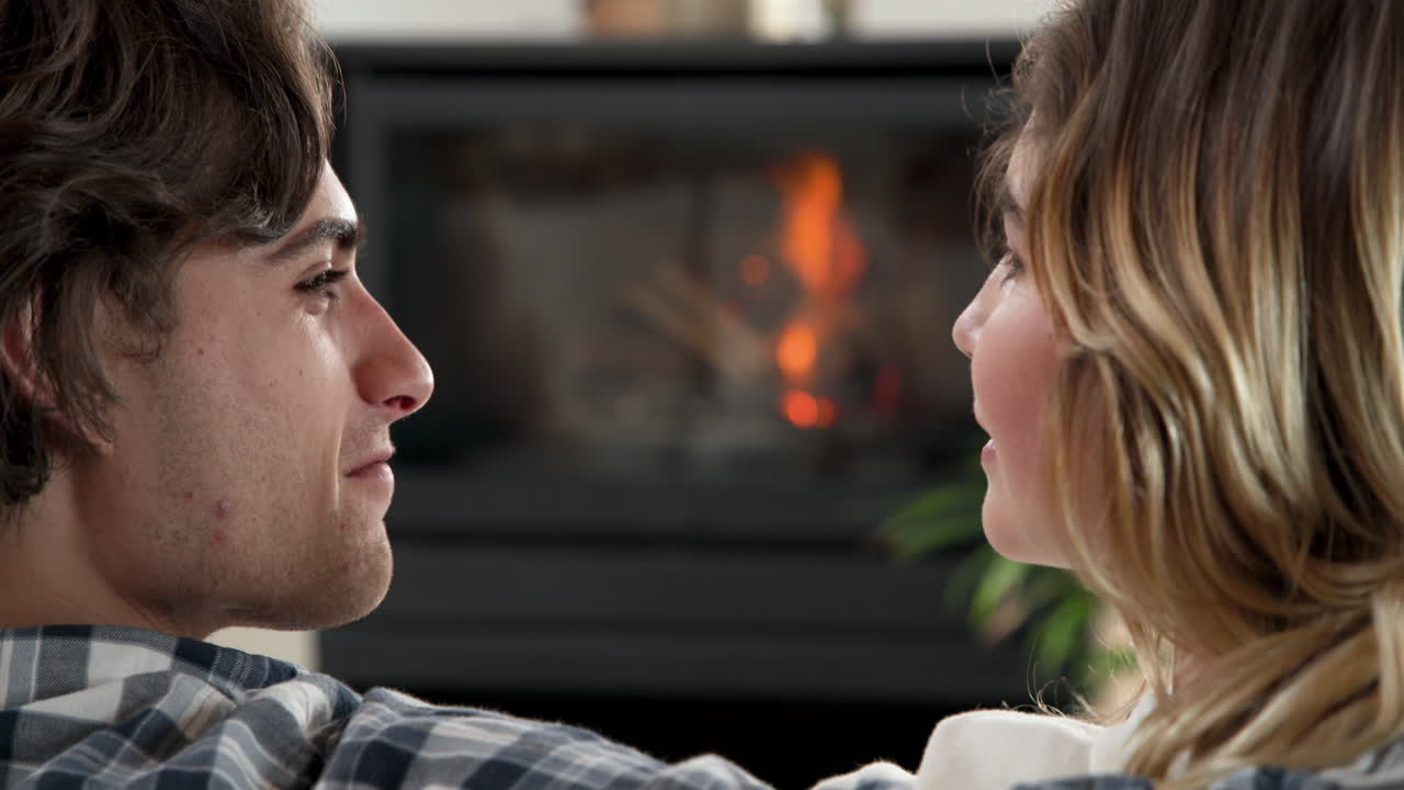 Christmas time, Couple relaxing by cozy fireplace, enjoying warm holiday moments together, copy spac