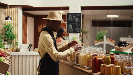 local farmer arranging eco friendly merchandise at supermarket