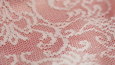 white lace on pink silk close-up, guipure texture and satin luxury cloth background. luxurious design textile. wedding dress