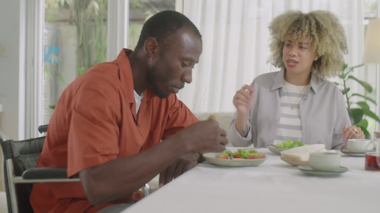 Man with Disability Having Dinner with Wife