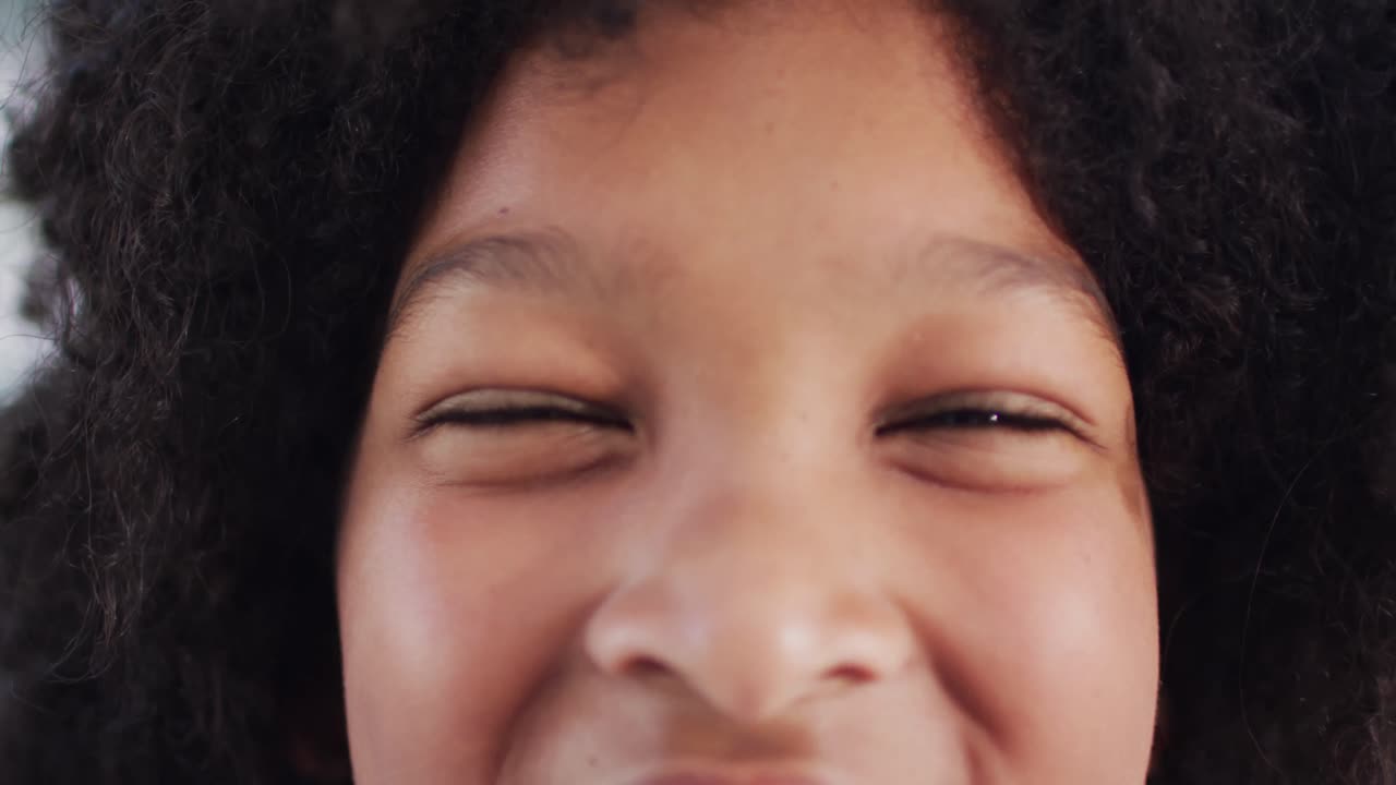 Portrait of happy african american schoolboy smiling in school classroom